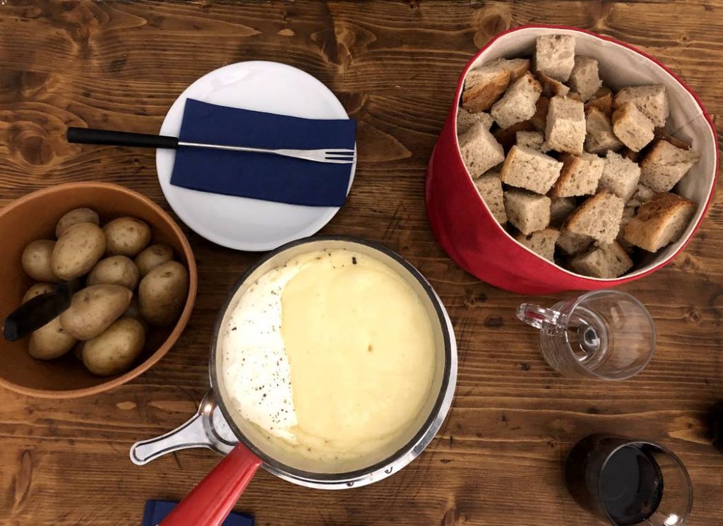 mesa de fondue acompanhado de batata e pão 